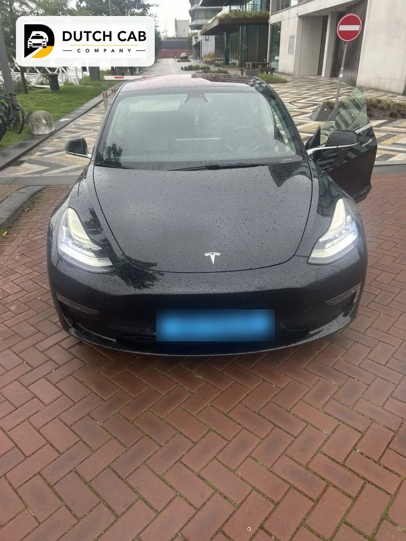 Zwarte Tesla Model 3 van Dutch Cab Company klaar voor een stadsrit in Amsterdam
